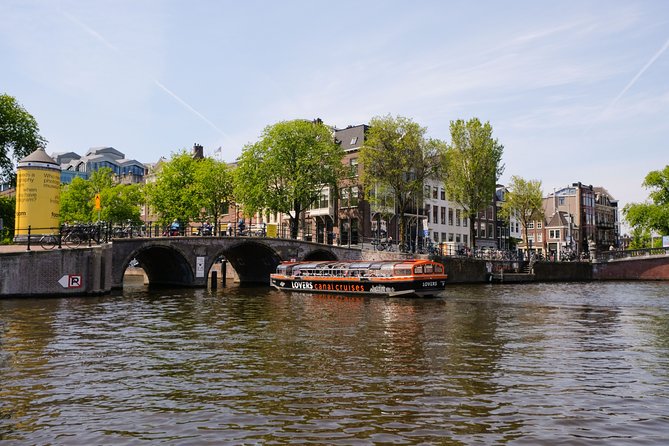 Amsterdam 1h Canal Cruise by Semi-Open Boat with Audio Guide - Audio guide and live skipper commentary