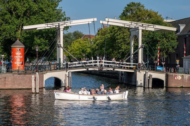 Amsterdam: 75 minute Open Boat Canal Cruise with Live Guide - Open-air comfort, photos, and weather