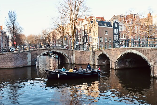 Amsterdam Canal Tour by Open Boat – 90 min Small Group Experience - Locks, warehouses, and the edge of Chinatown