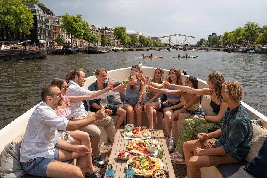 Amsterdam: German Guided Canal Cruise with on Board Bar - The first views: Dancing Houses and Zuiderkerk