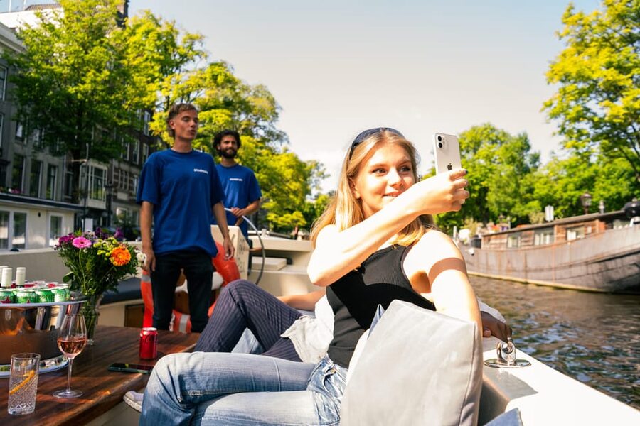 Amsterdam: German Guided Canal Cruise with on Board Bar - Munttoren and Oude Kerk: Amsterdam’s older core