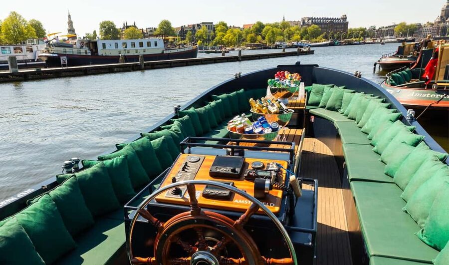 Amsterdam: Guided Open Boat Canal Cruise Including Drink - Seven bridges, elegant houses, and the Nine Streets