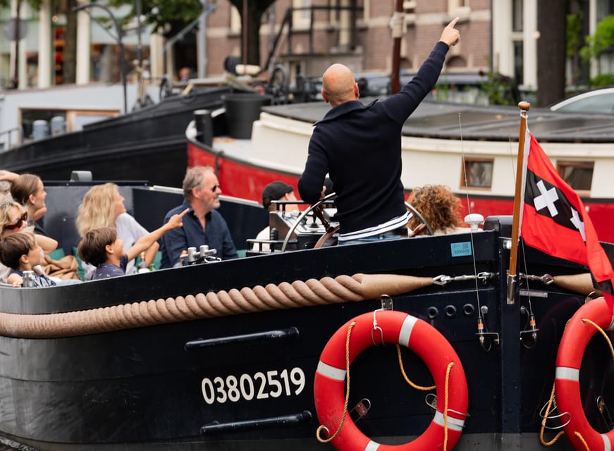 Amsterdam: Guided Open Boat Canal Cruise Including Drink - What the guide adds to the ride