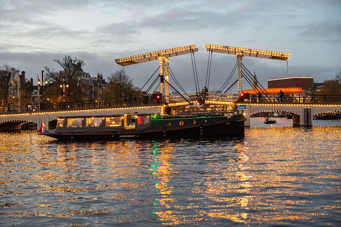Amsterdam: Light Festival Open Boat - Unl. Drinks Option - The 1516 watchtower with a strange clock