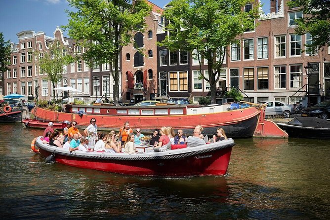Amsterdam Light Festival: Saloon Boat Cruise + Hot Drinks & Bite - A night route through Amsterdam’s glowing canals