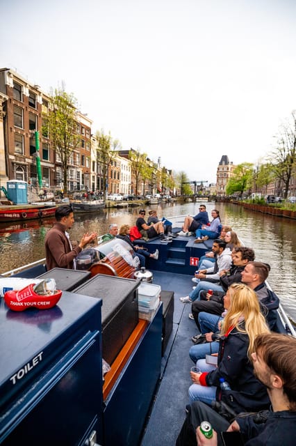 Amsterdam:Old City Canal Cruise with Live Guide and Open Bar - The first views: bridges, canal houses, and houseboats