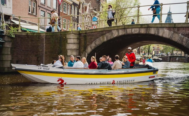 Amsterdam: Open Boat Tour of Canals with Expert Local Guide - Why a small open boat changes Amsterdam