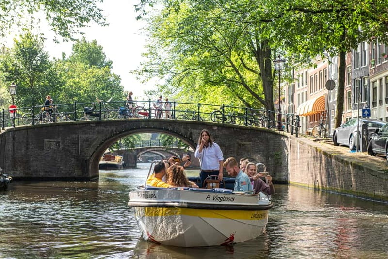 Amsterdam: Open Boat Tour of Canals with Expert Local Guide - Leaving Damrak and passing Amsterdam Centraal