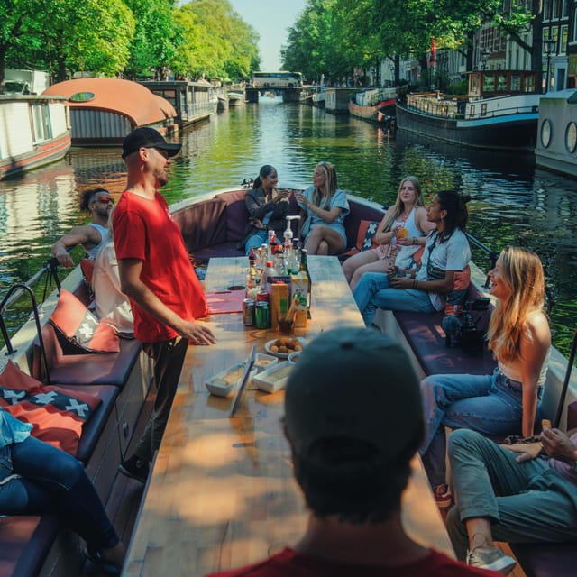 COZY AND FUN CANAL TOUR: A UNIQUE JOURNEY THROUGH AMSTERDAM - Magere Brug and Munttoren