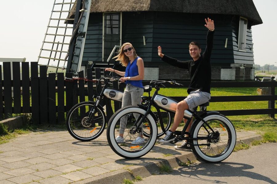 Volendam: E-Fatbike Rental - Green fields, grazing animals, and a working windmill